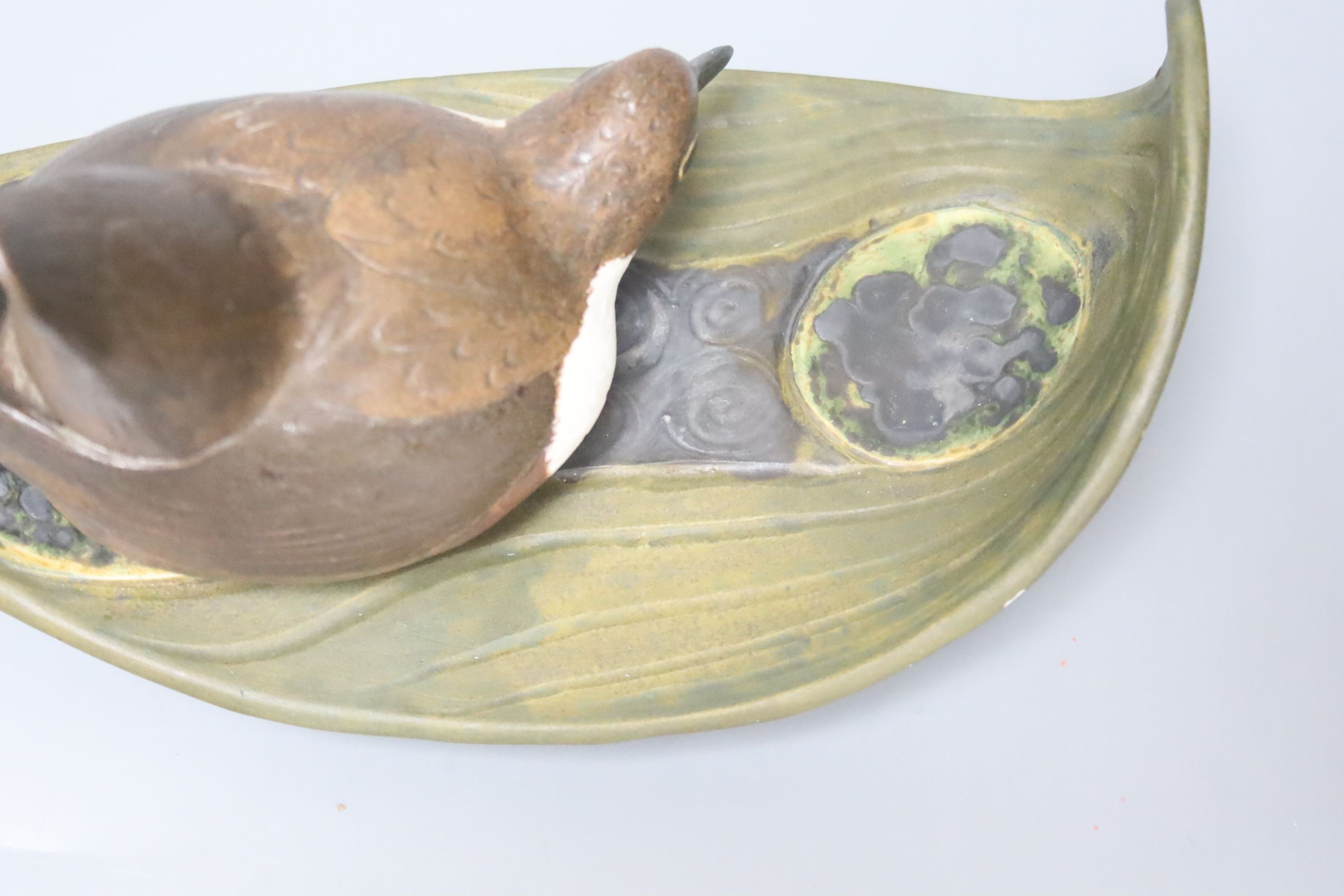 A Norman Makinson Studio pottery 'bird on leaf', length 23cm